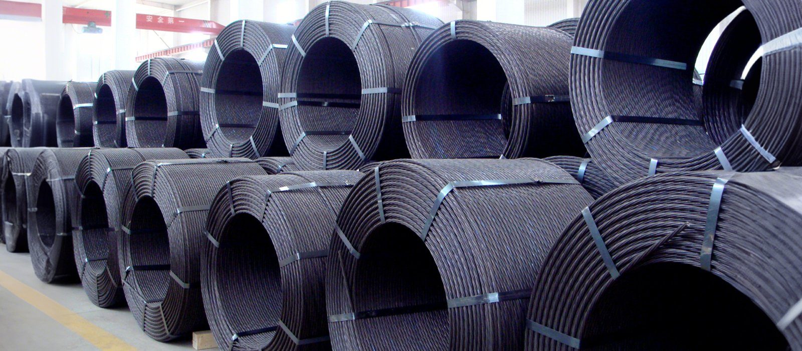 Strapped coils of prestressed concrete steel strand ready for shipment