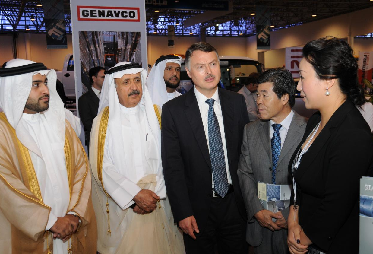 Global Overseas representatives in conversation with visitors at an exhibition booth